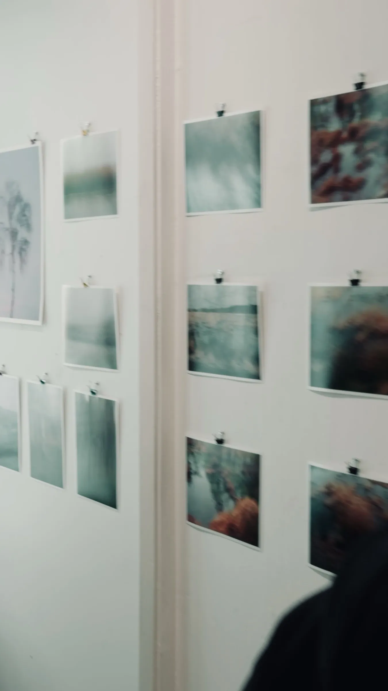 Short video: photographs sorted on a white table, then the finished wall of pictures