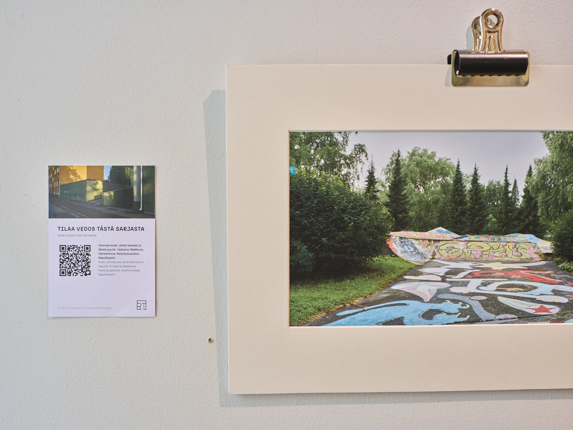 White information panel with Finnish text and QR code beside a clipped photograph of a painted skate park