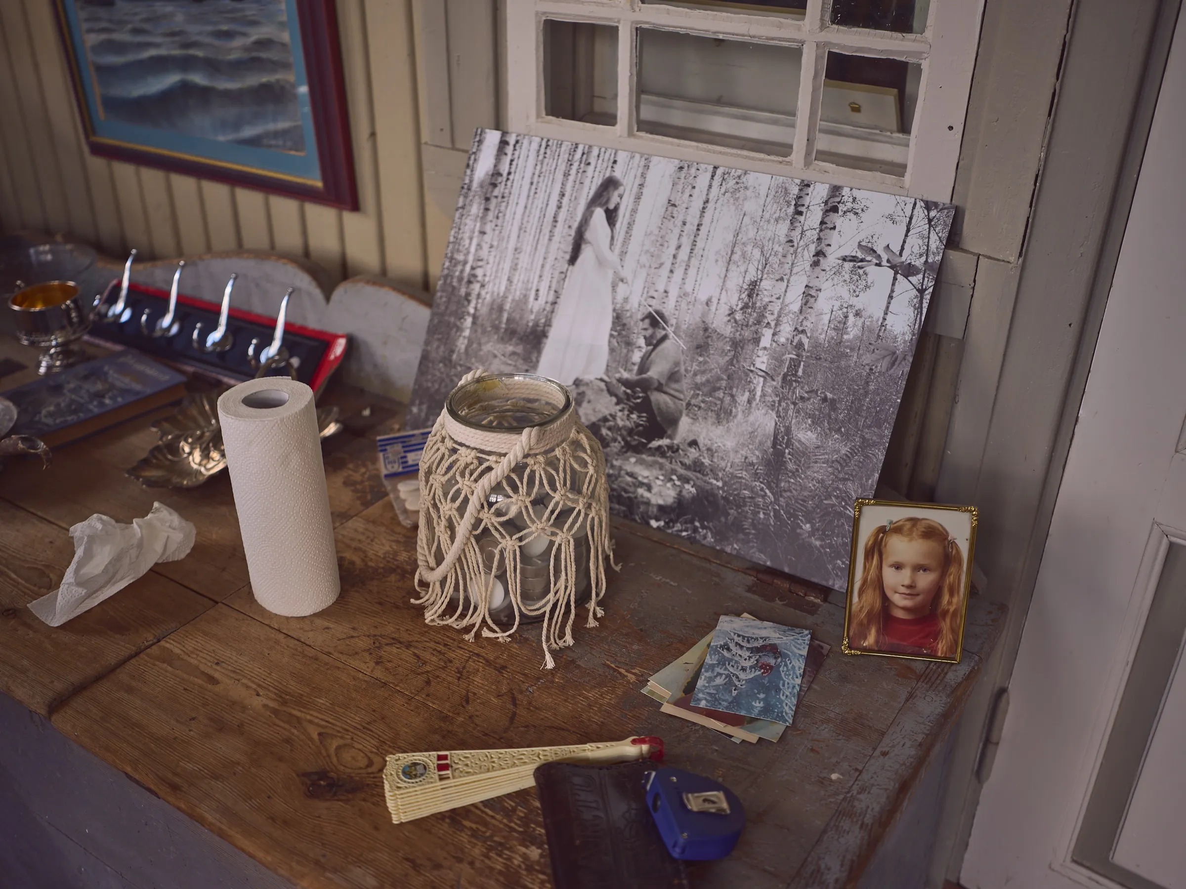 Veranda table with a black and white photograph on canvas and a small portrait of a girl