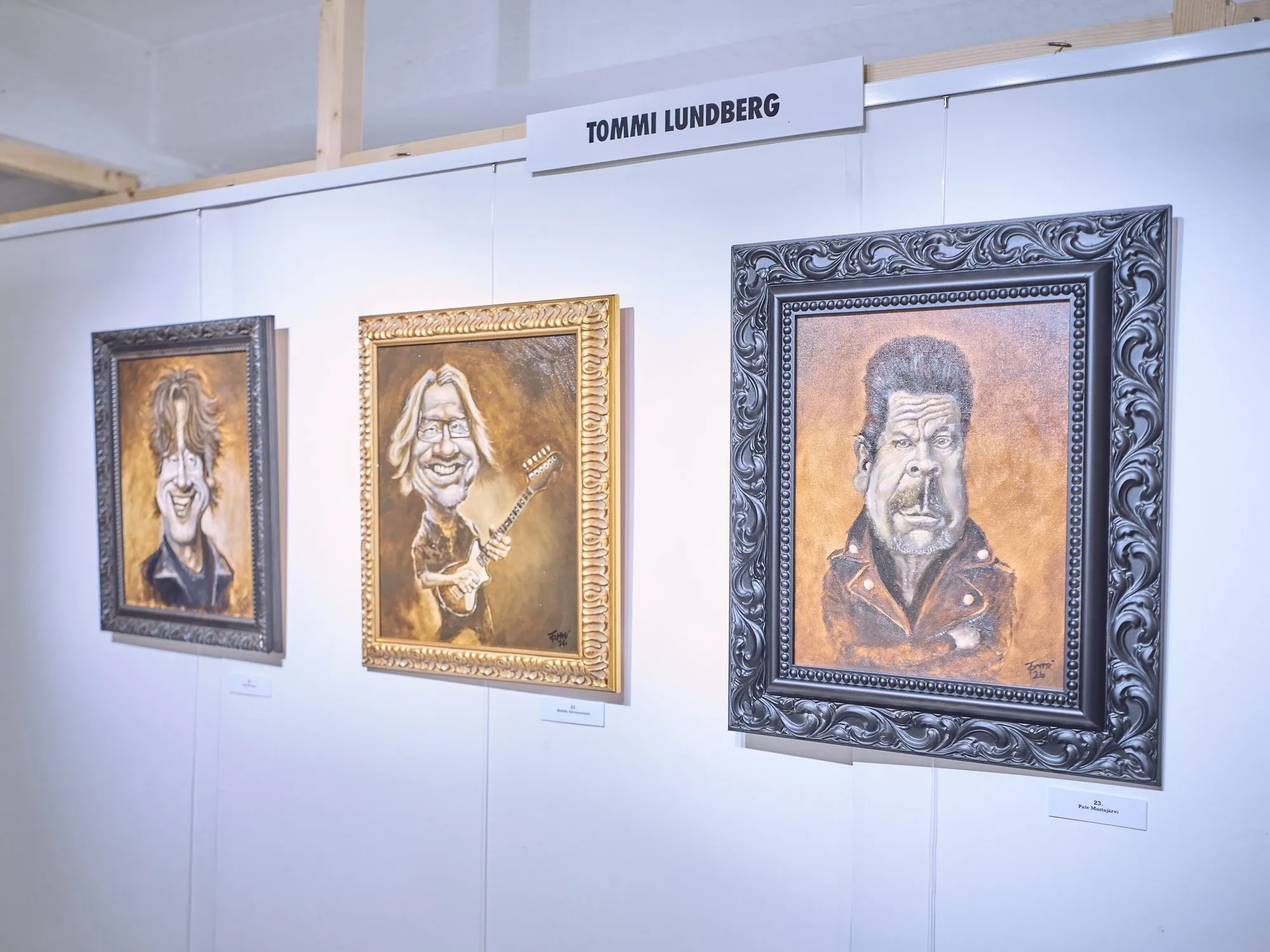 Three oil caricatures by Tommi Lundberg, musicians with big heads in ornate frames