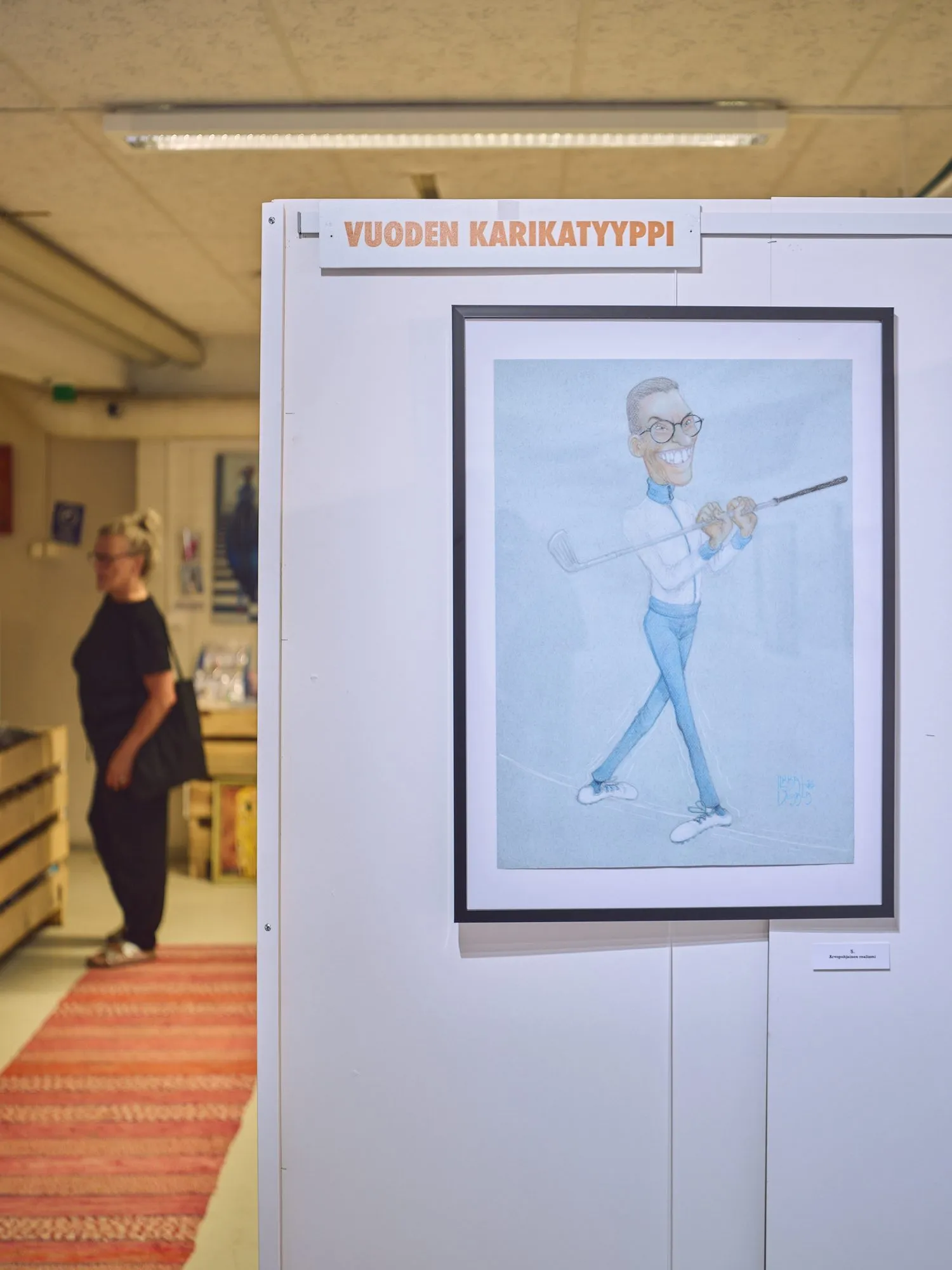 Framed caricature of Stubb in an athletic pose under the heading Vuoden karikatyyppi, portrait format