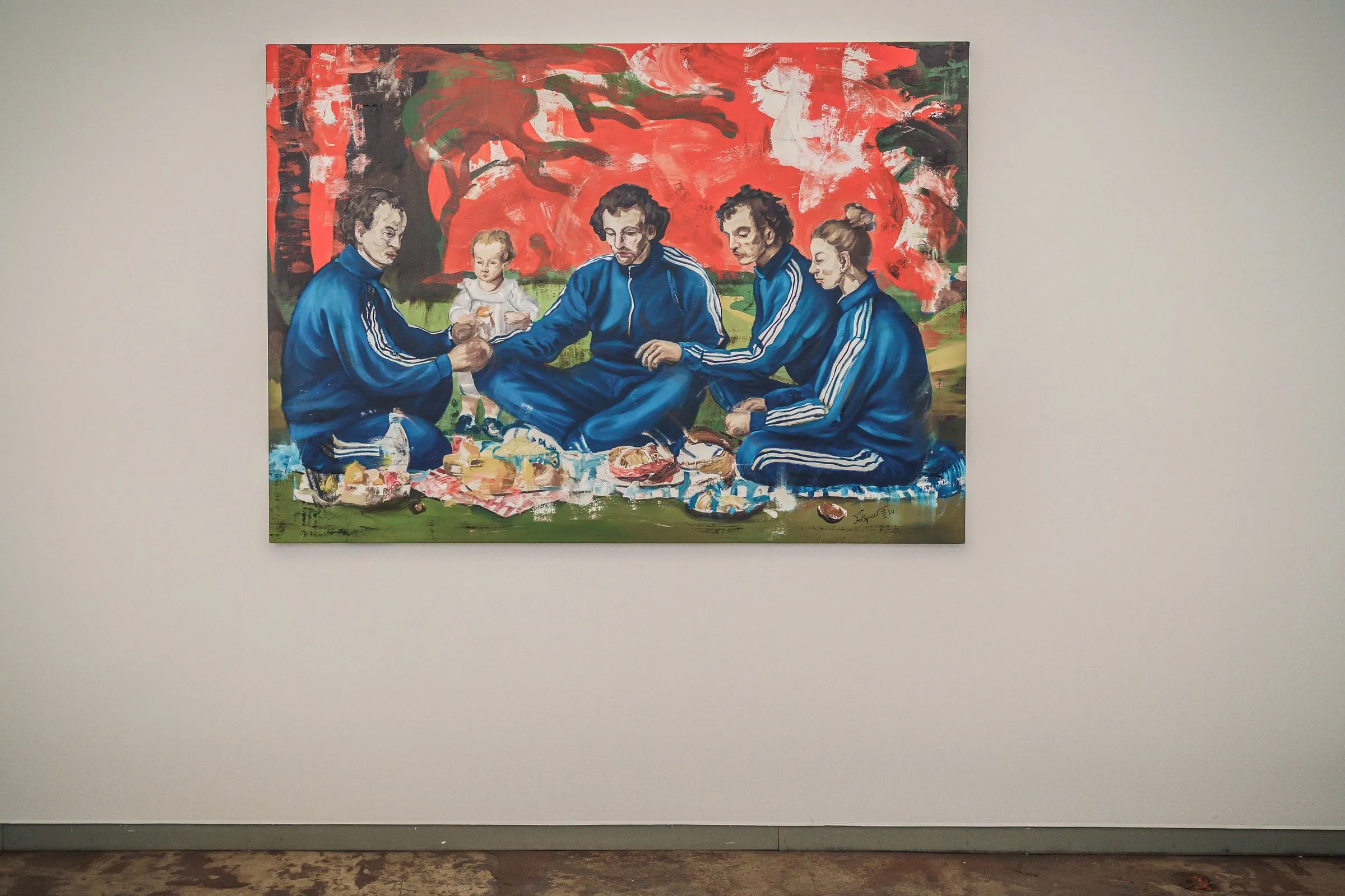 A painting with men in blue tracksuits having a picnic against a red background