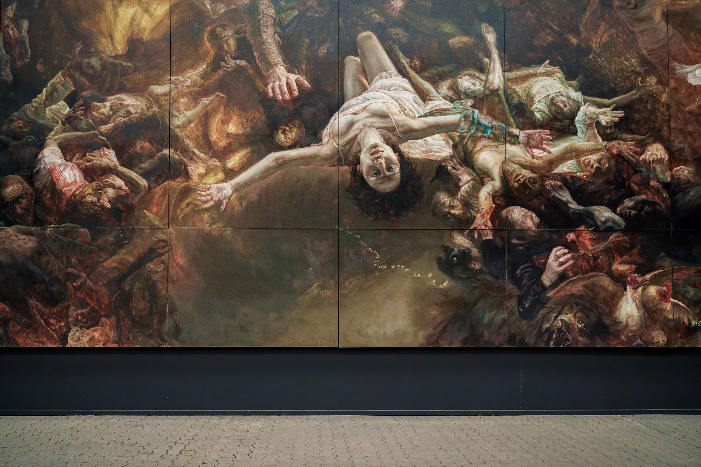 Detail of the painting: bodies tumbling into each other, a person with outstretched arms in bright light