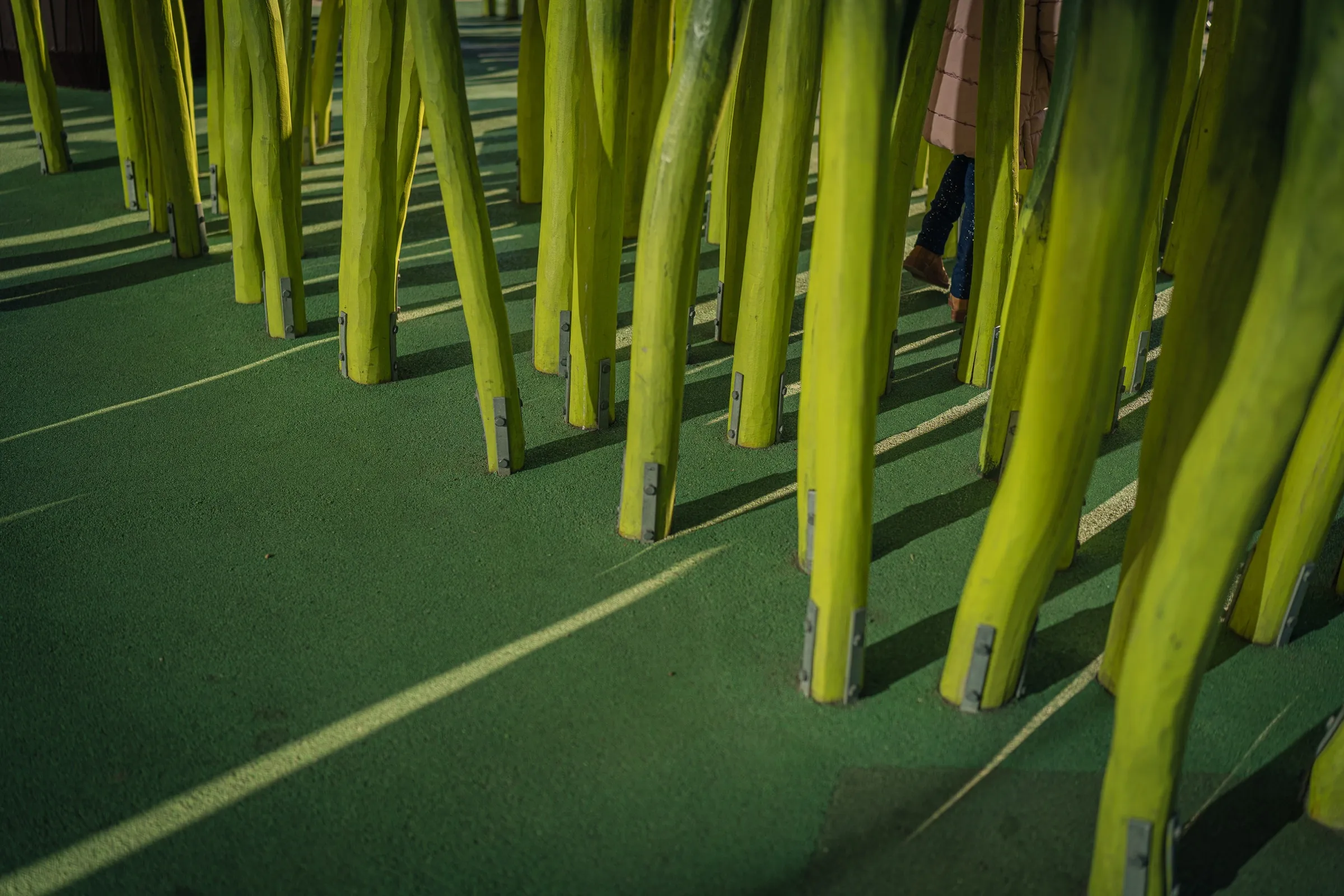Dense, tall green steles like giant blades of grass on green ground