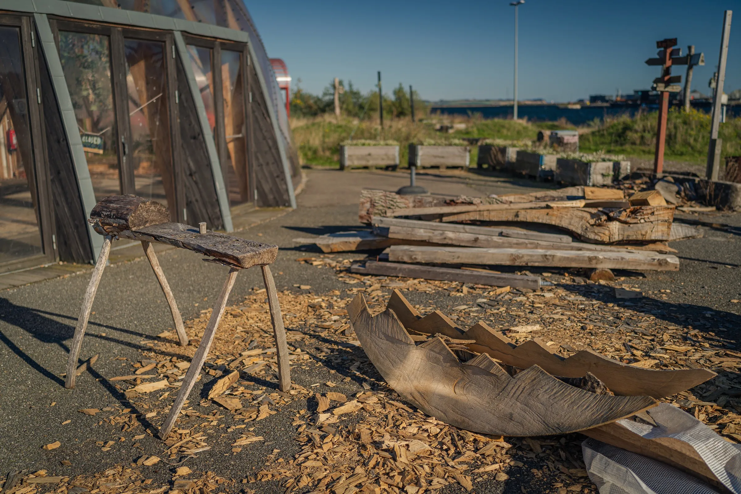 Wood offcuts, workbenches and beams on the area beside the dome