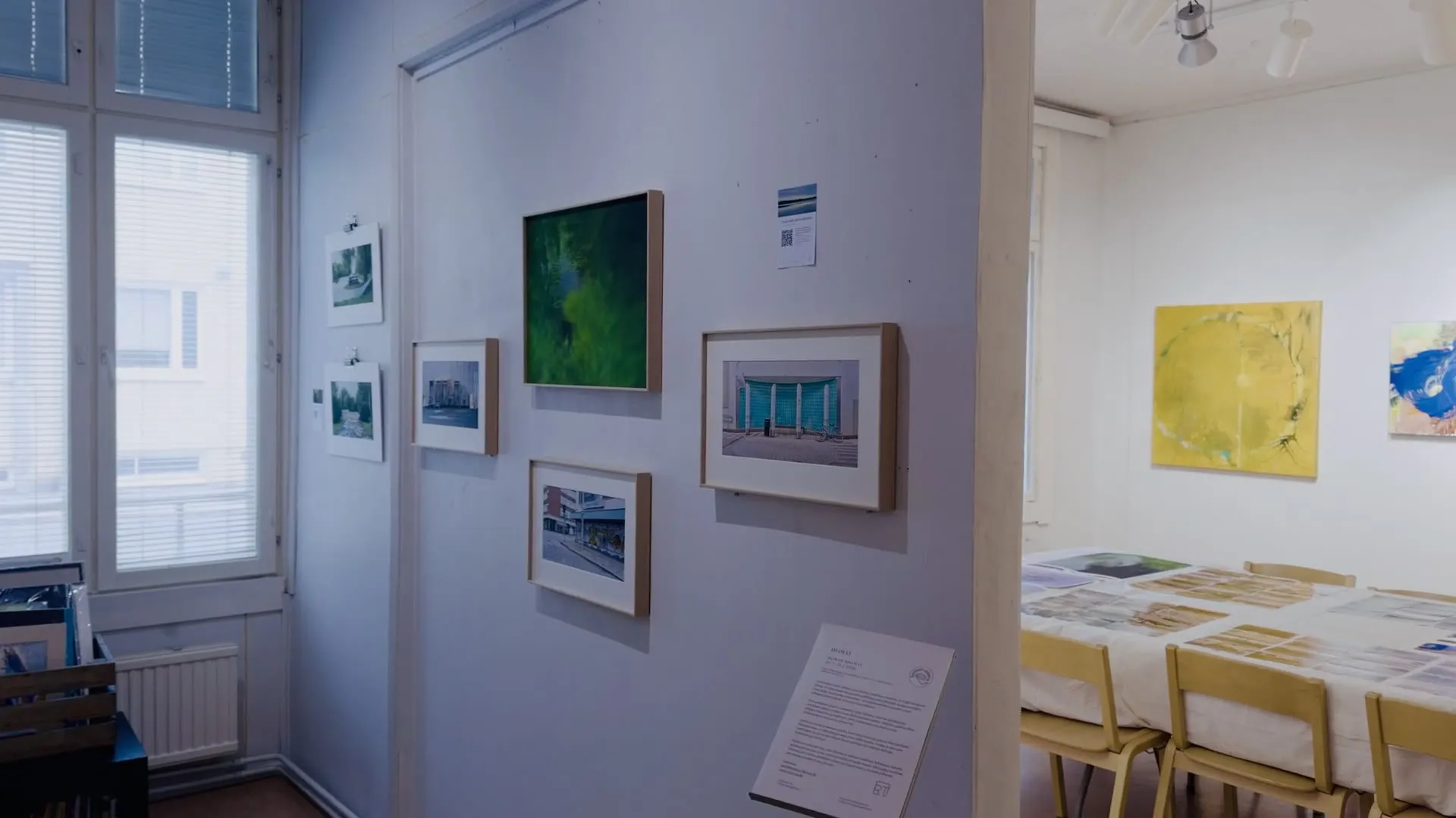 Video: slow pan along the exhibition wall, past framed photographs and the information panel